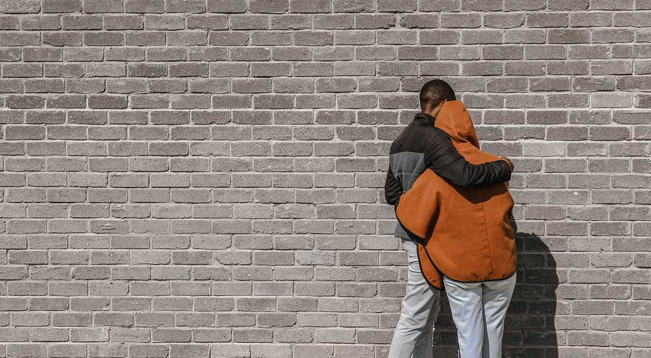 people saying sorry turned to a wall