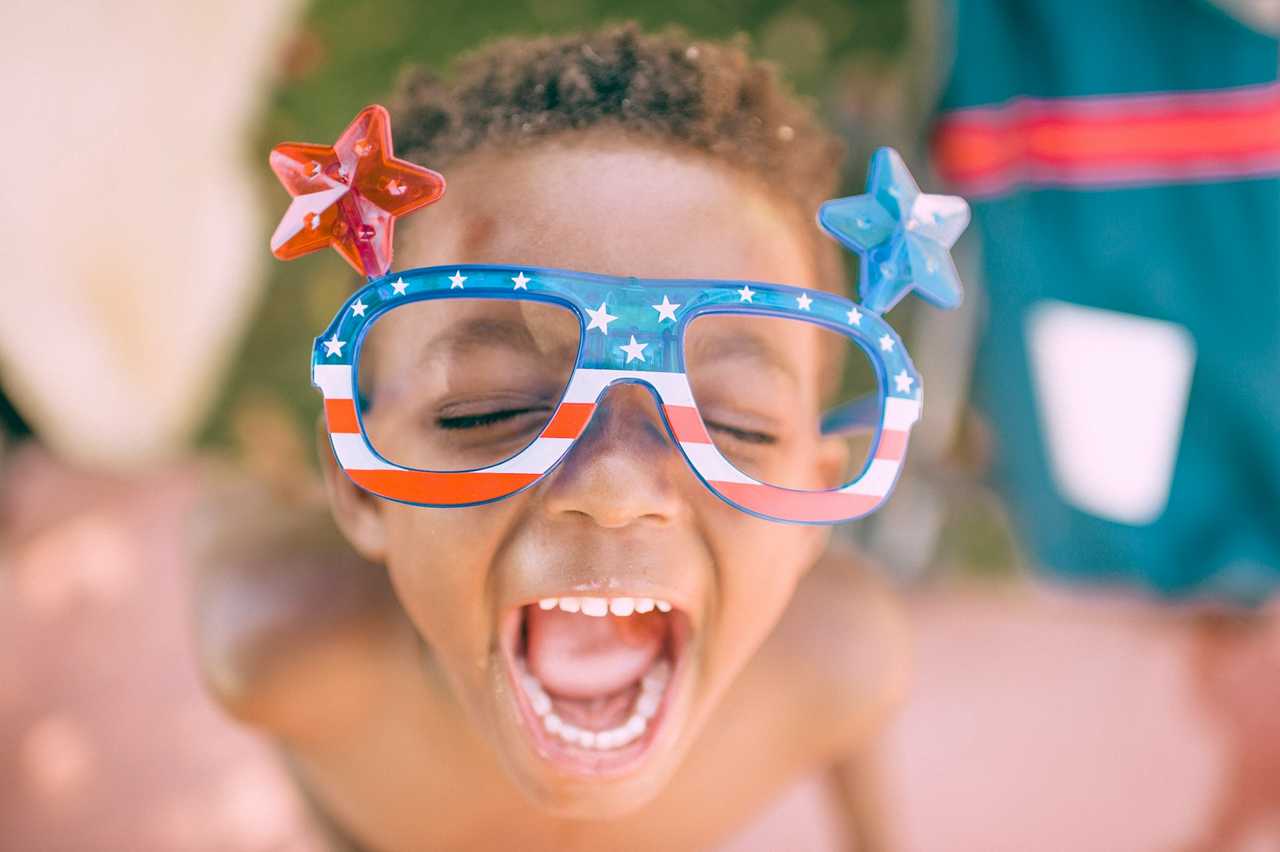 kid shouting wearing US themed glasses for 4th of July independence day