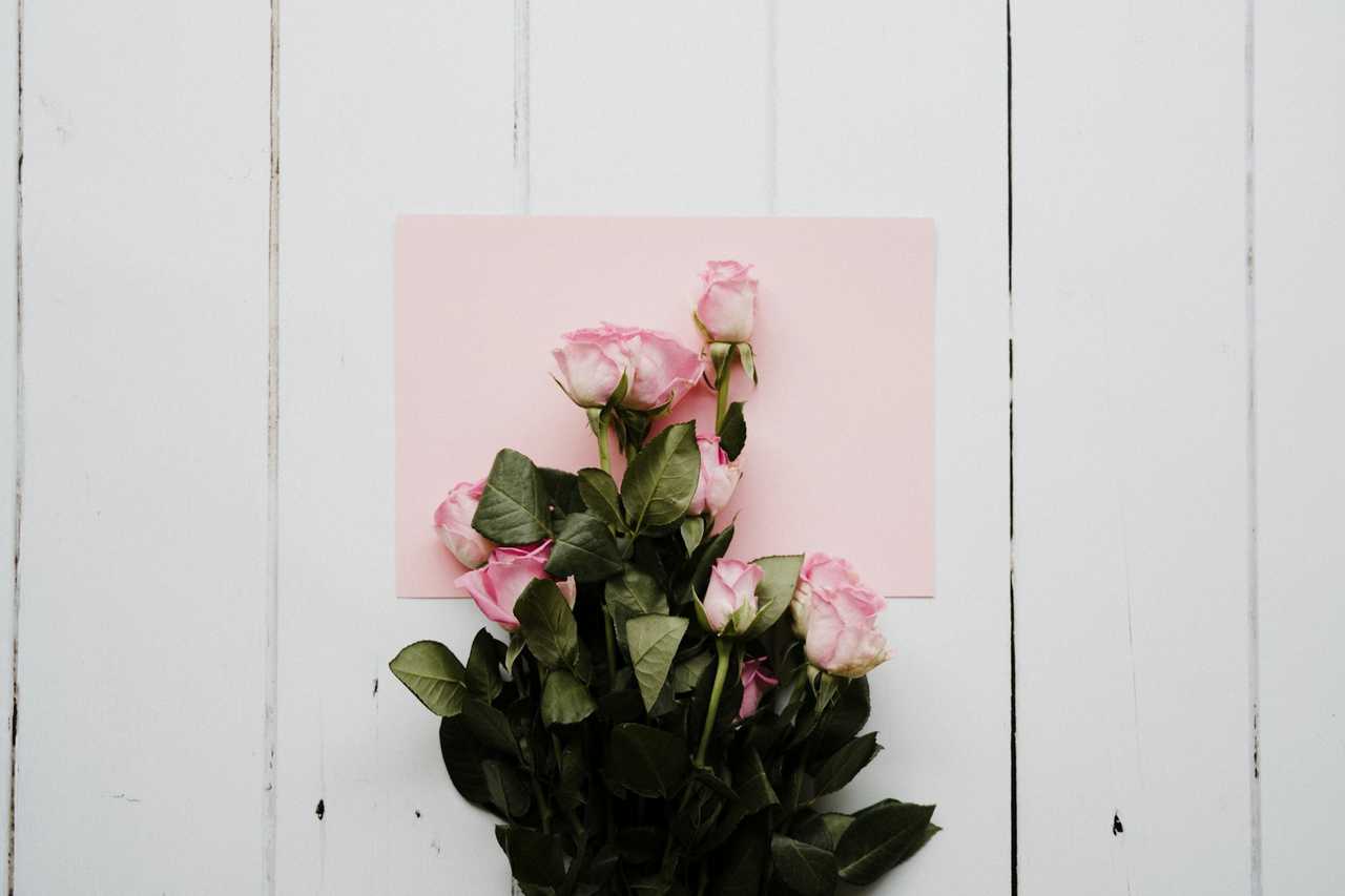 flowers and card over white wooden surface for a virtual happy valentines day wish to wife