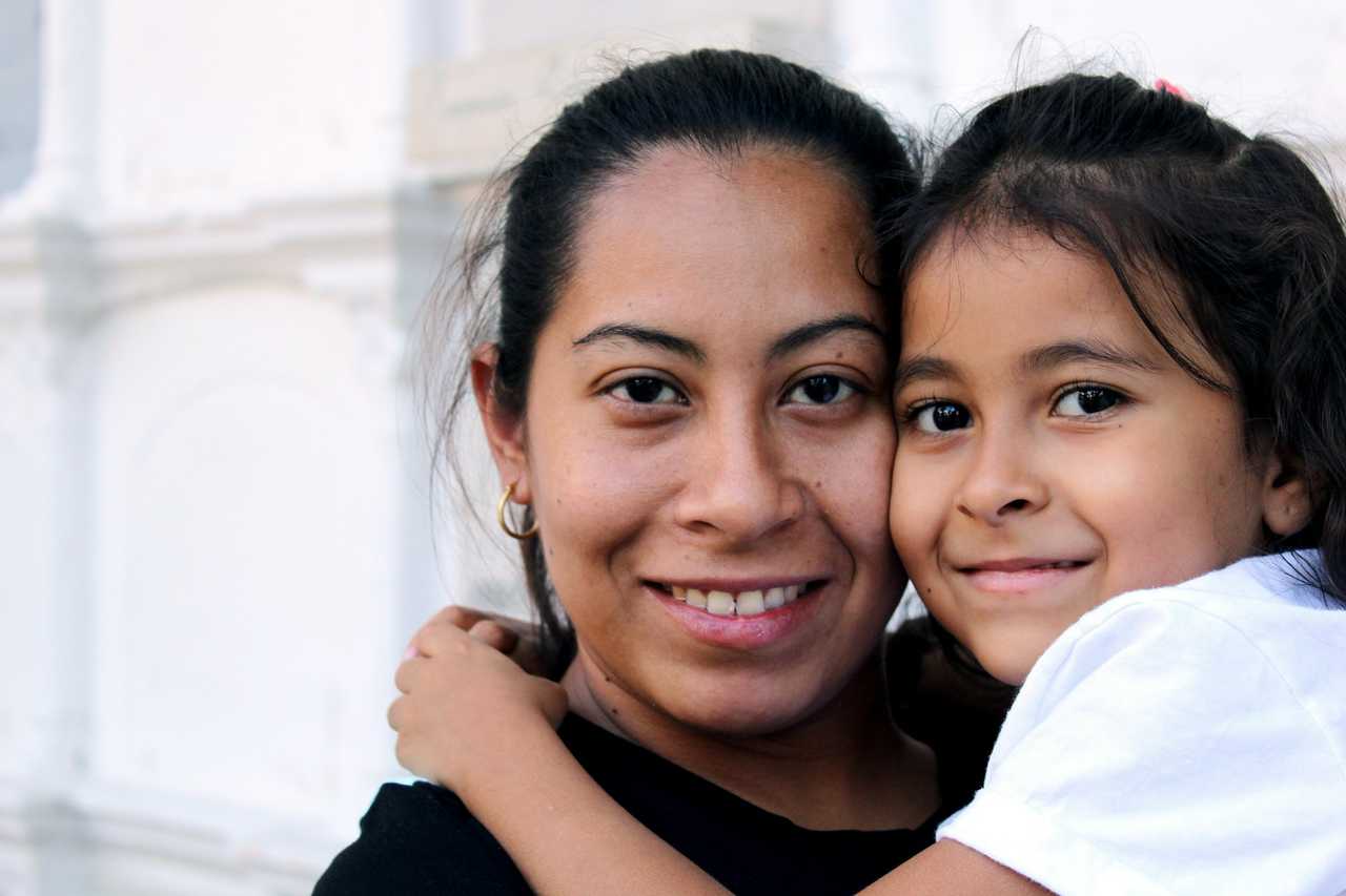 mother hugging daughter and smiling for mother daughter quotes