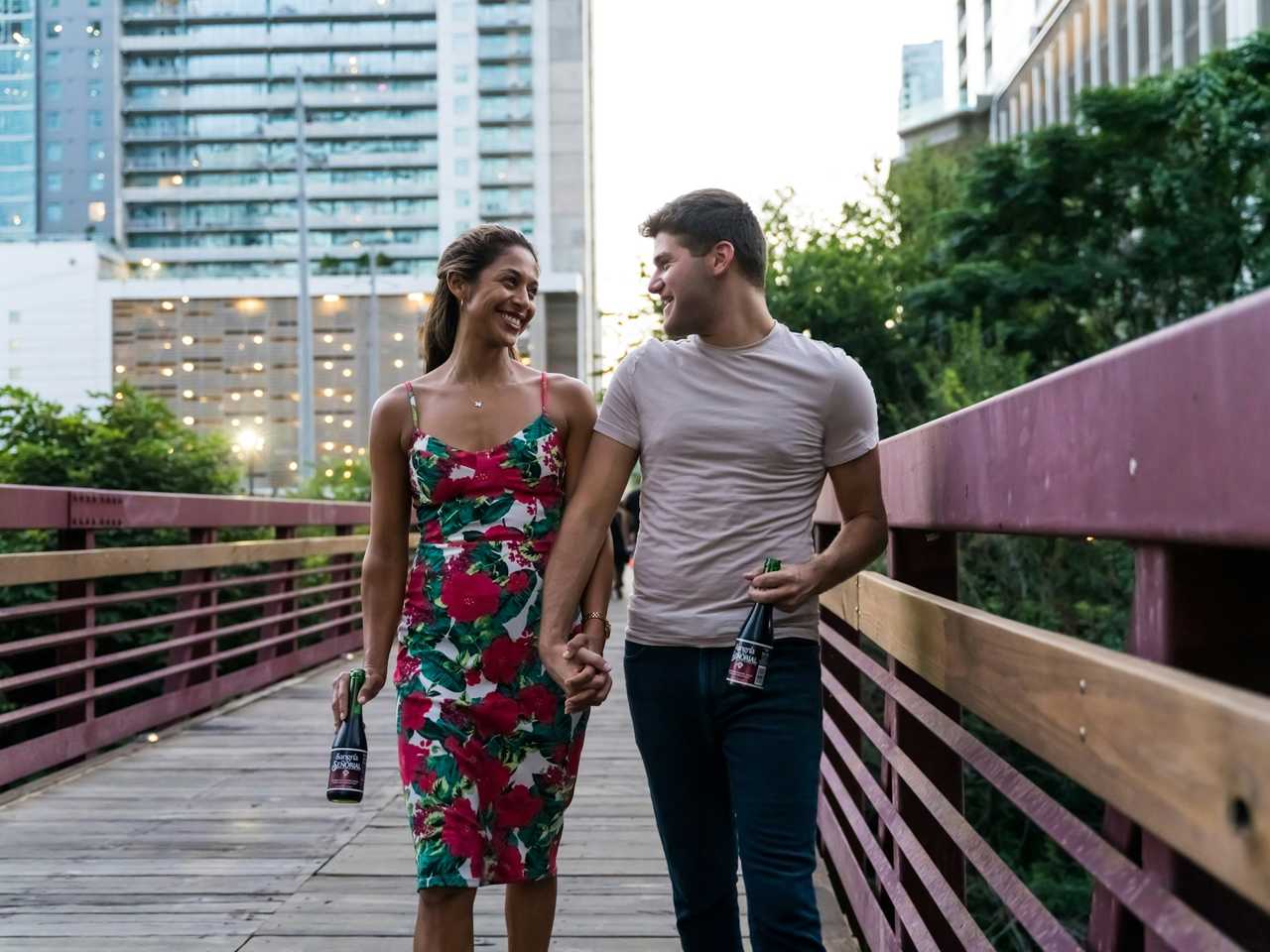 couple walking with hand tied smiling on first date following the no kiss rule on first date