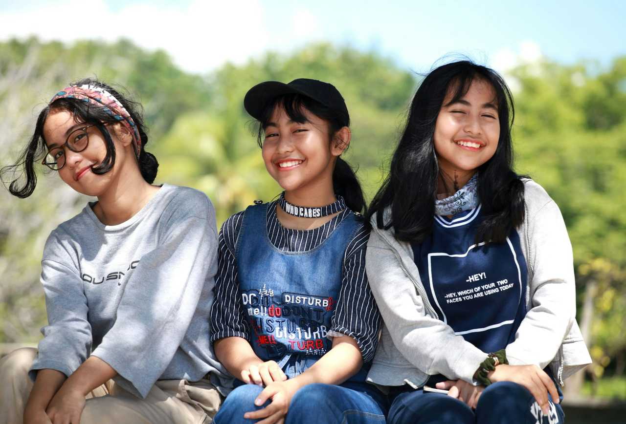 sisters seating side by side and smiling getting birthday wishes