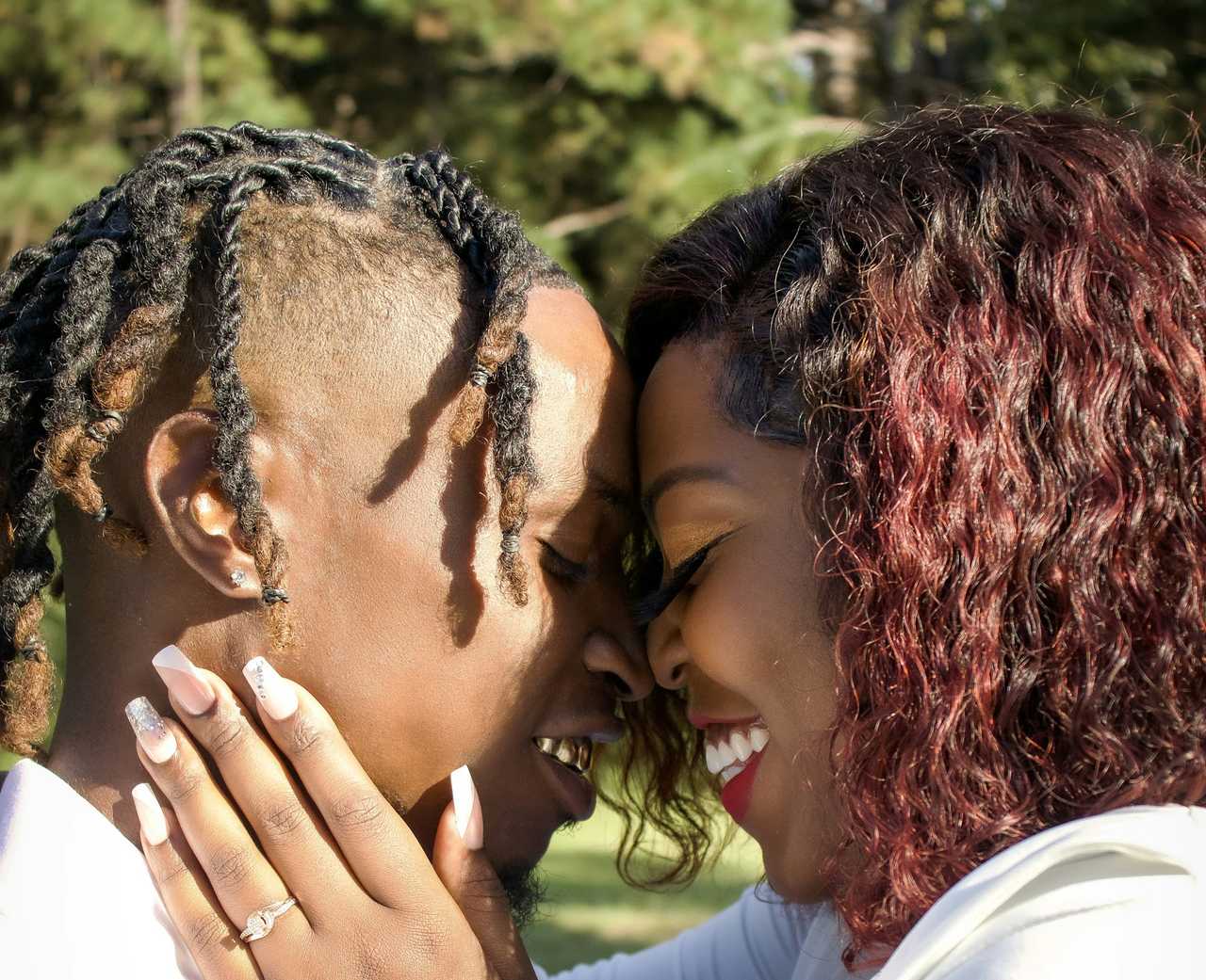 couple smiling with their faces together just after having their first kiss
