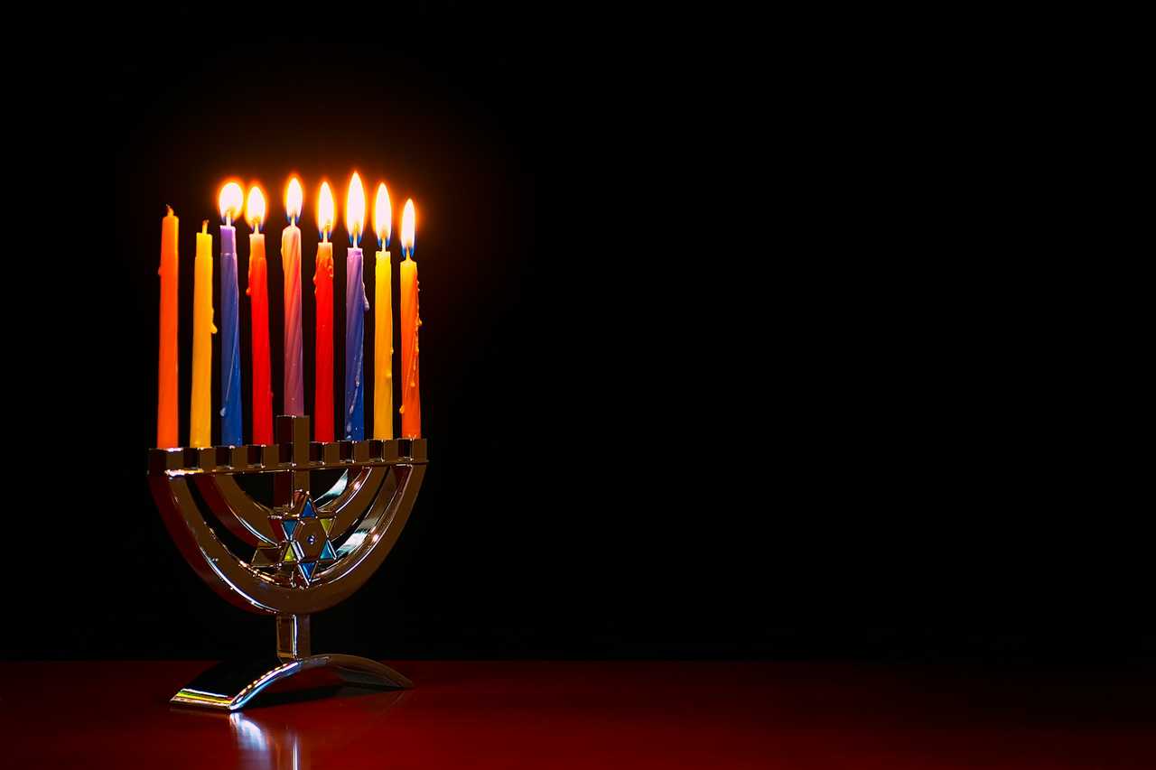 hanukkiah with coloured candles to send hapy hanukkah greetings