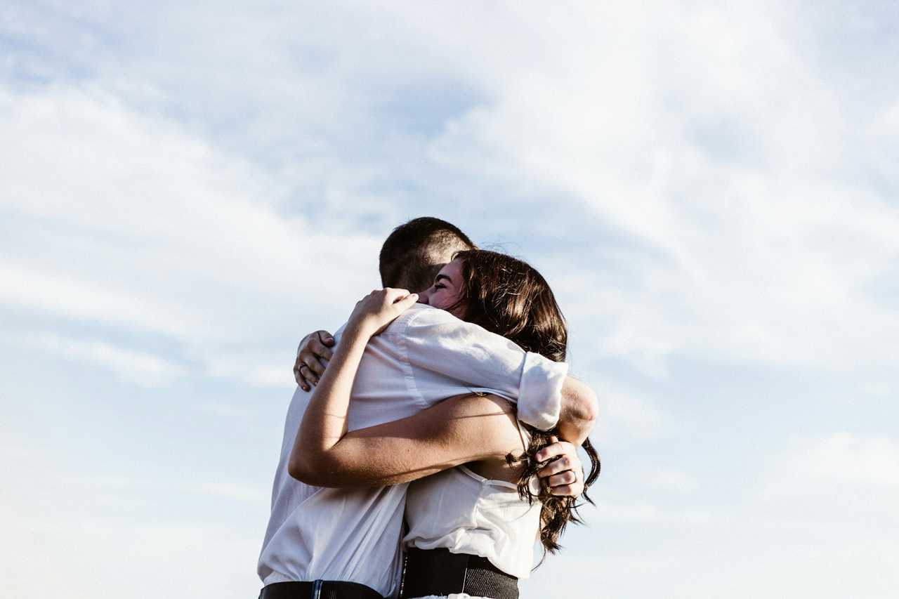 couple in a warm hug after their first kiss