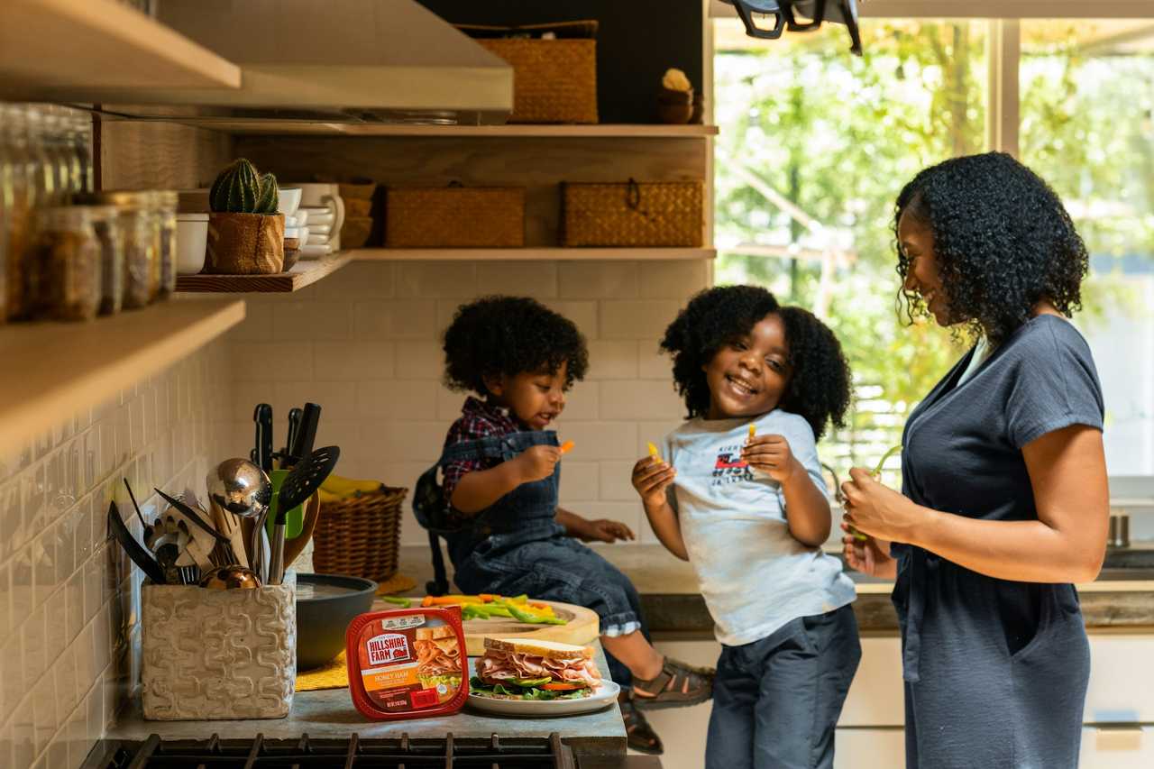 mom and her two daughters in the kitchen having snacks happy mother's day messages