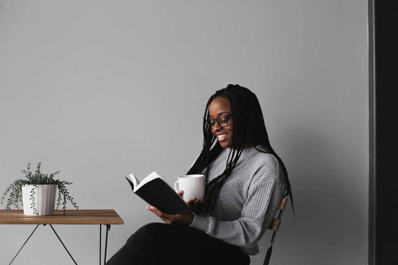 woman seated reading poems and smiling after receiving good morning wife quotes