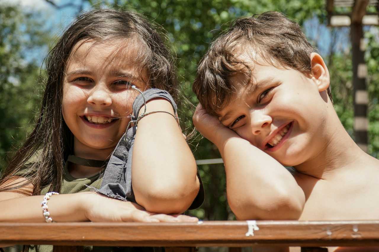 young siblings smiling at the camera