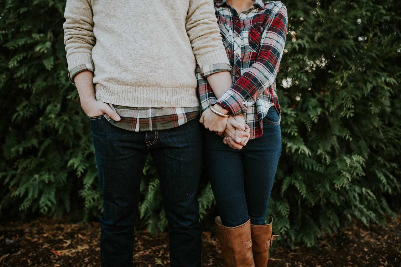 couple holding hands next to a bush saying valentine's day quotes
