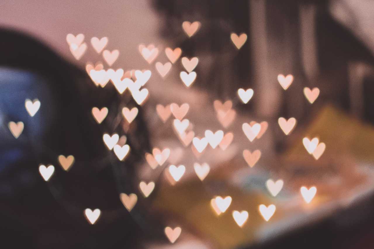 glitter heart floating over fuzzy room with romantic valentine's day quotes for him