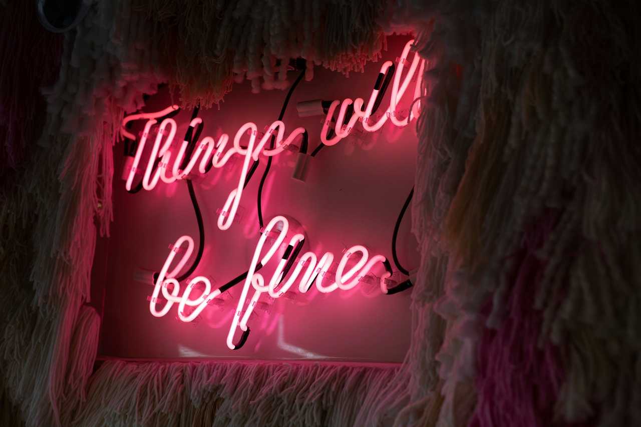 pink neon sign with a positive message saying things will be fine