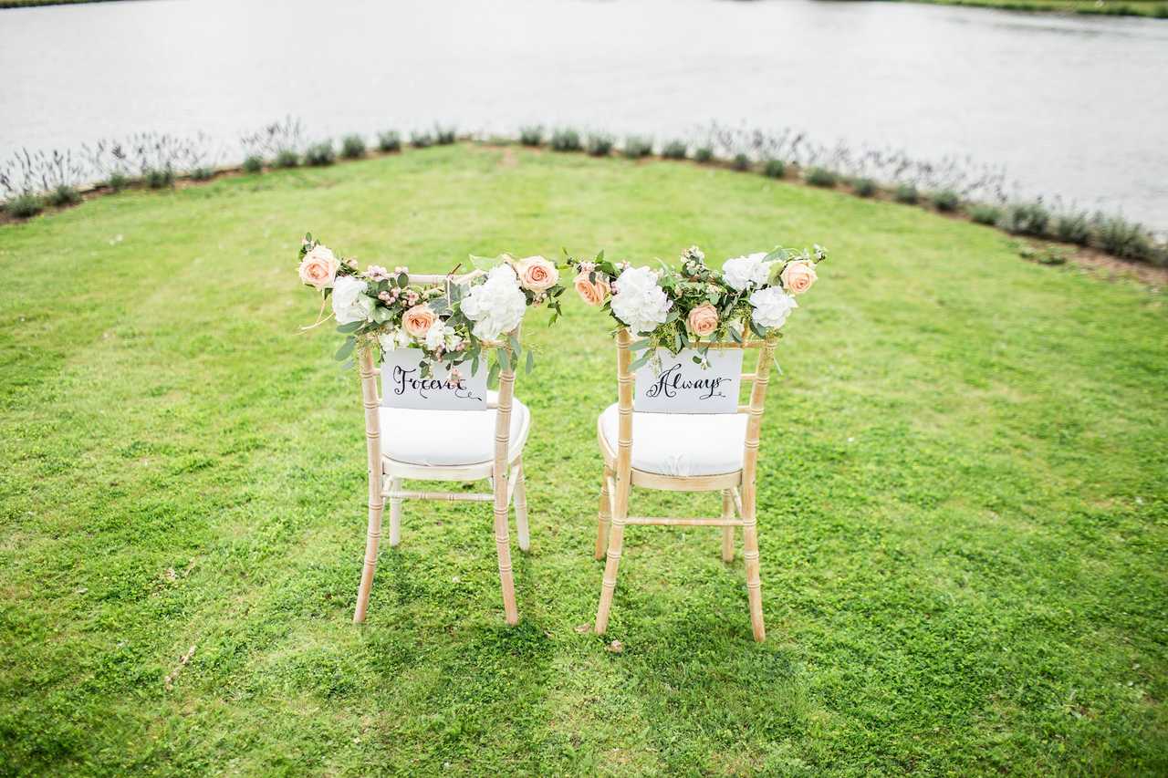 two chairs with forever and always written by a lake for a wedding anniversary message