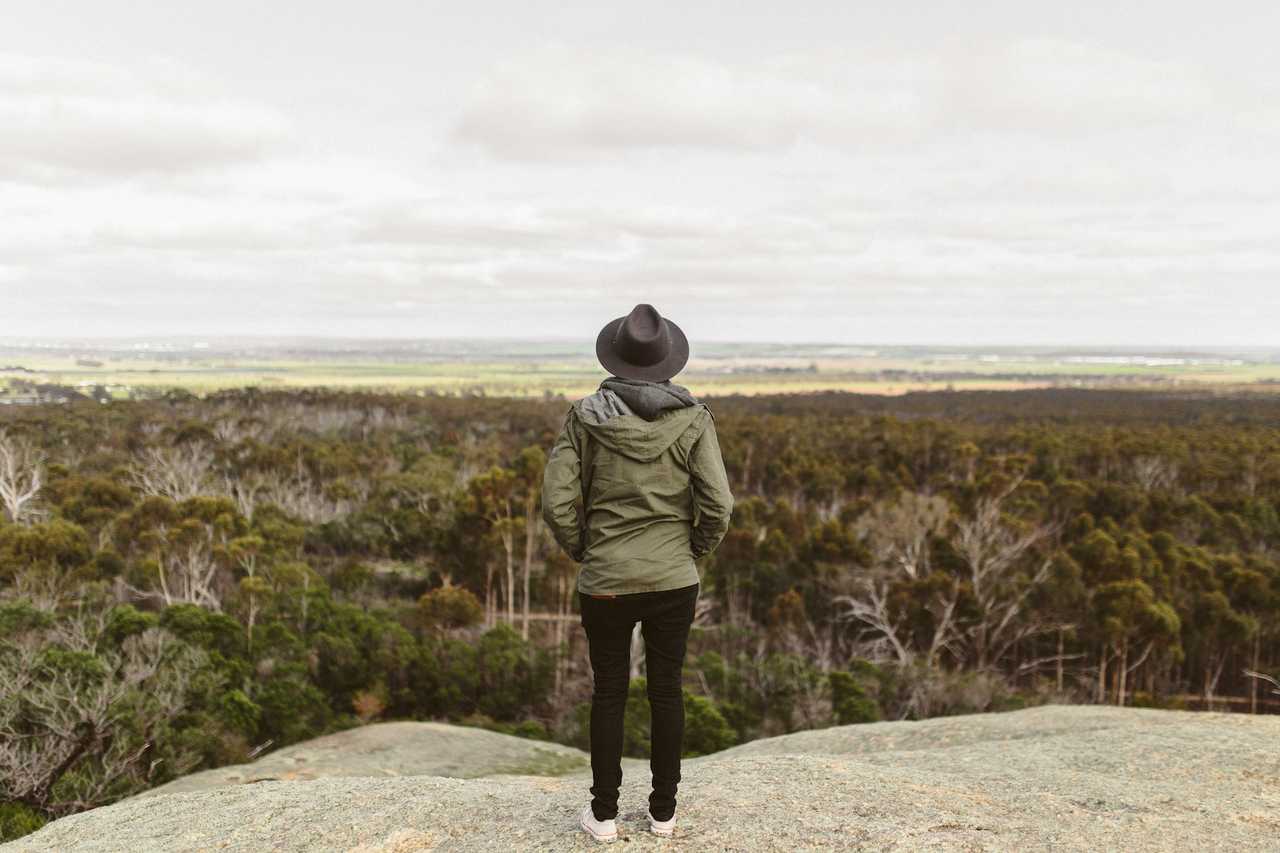 woman hiking looking at the landscape missing someone