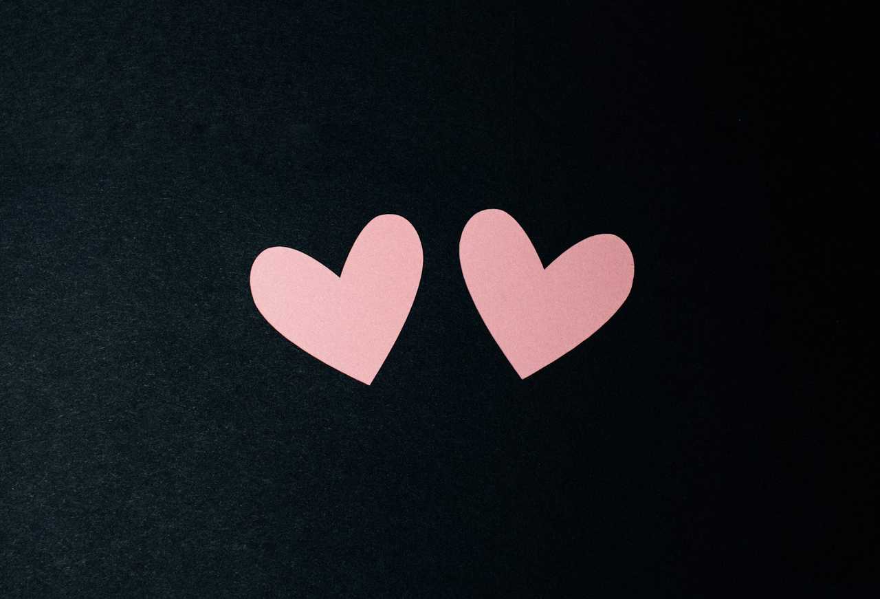 two pieces of paper cut in heart shaped for a love confession
