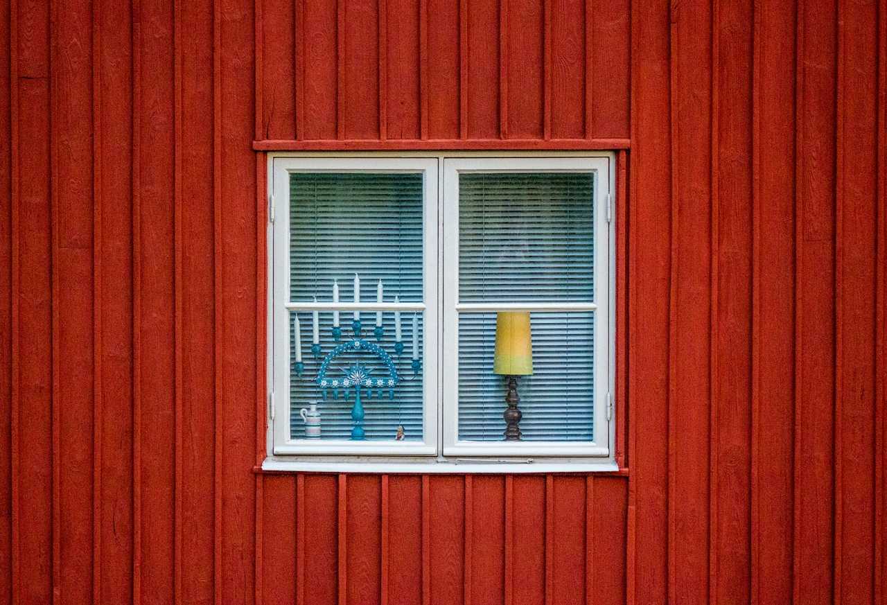 window in a red house with a hanukkiah on hanukkah