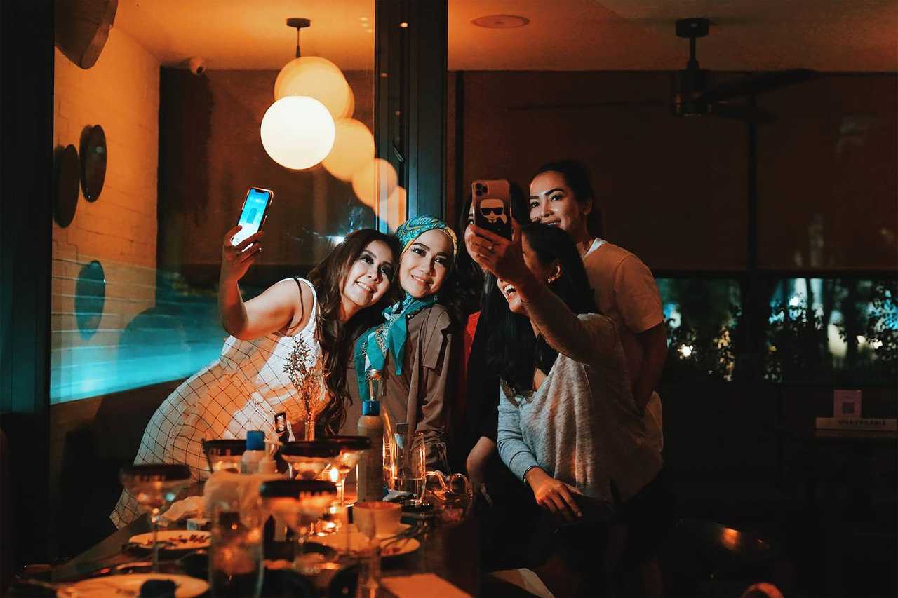 friends having fun at night sending good night friends