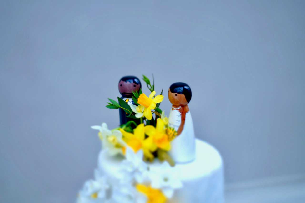 wedding cake with husband and wife miniatures on top with i love you wife messages