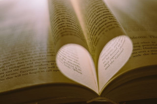 book pages making a heart shaper with short love poems for him