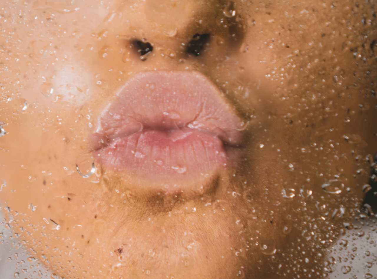 kissing mouth through a wet glass for the first kiss with someone
