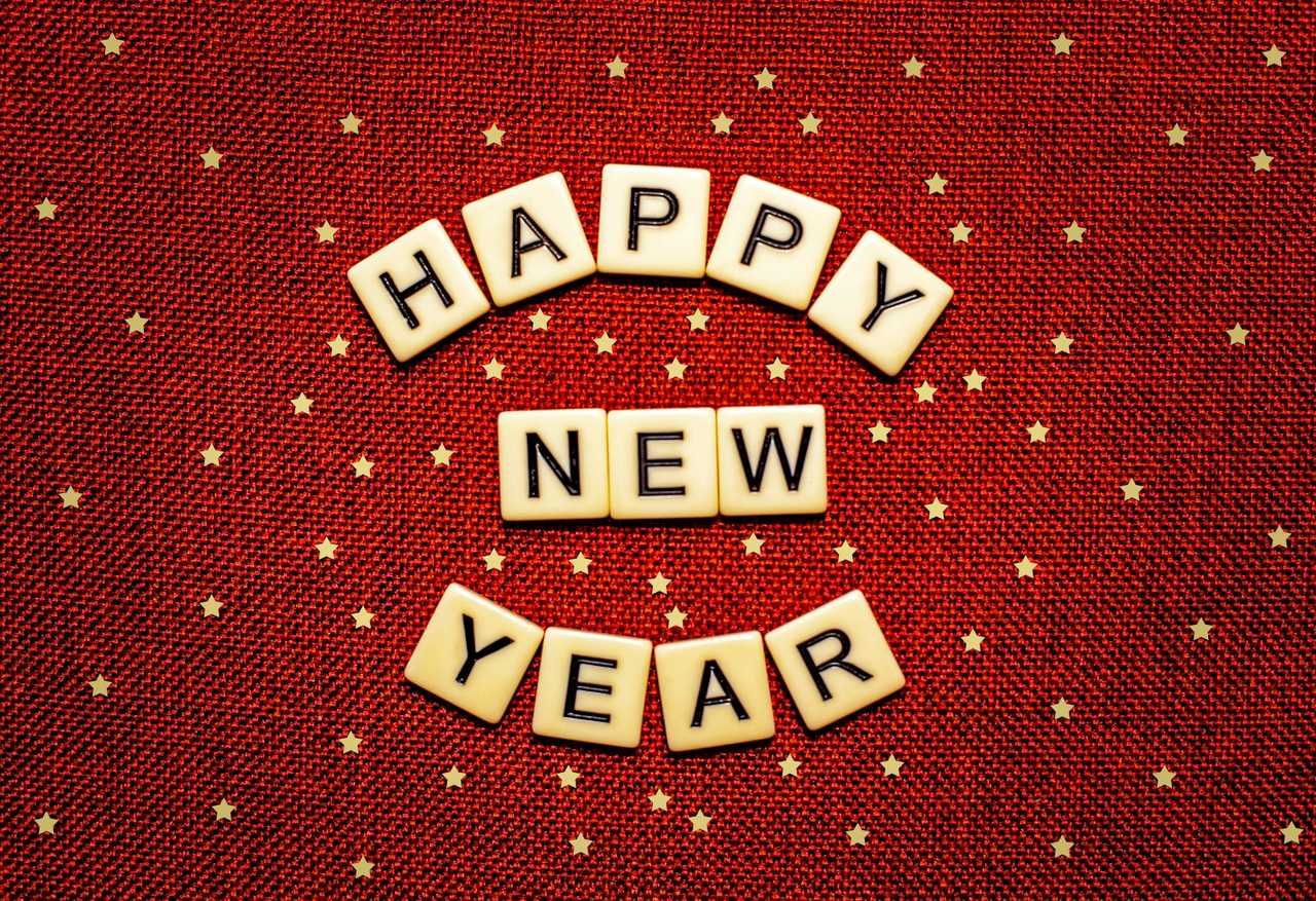 happy new year message in word tiles over a red background to send with funny wishes
