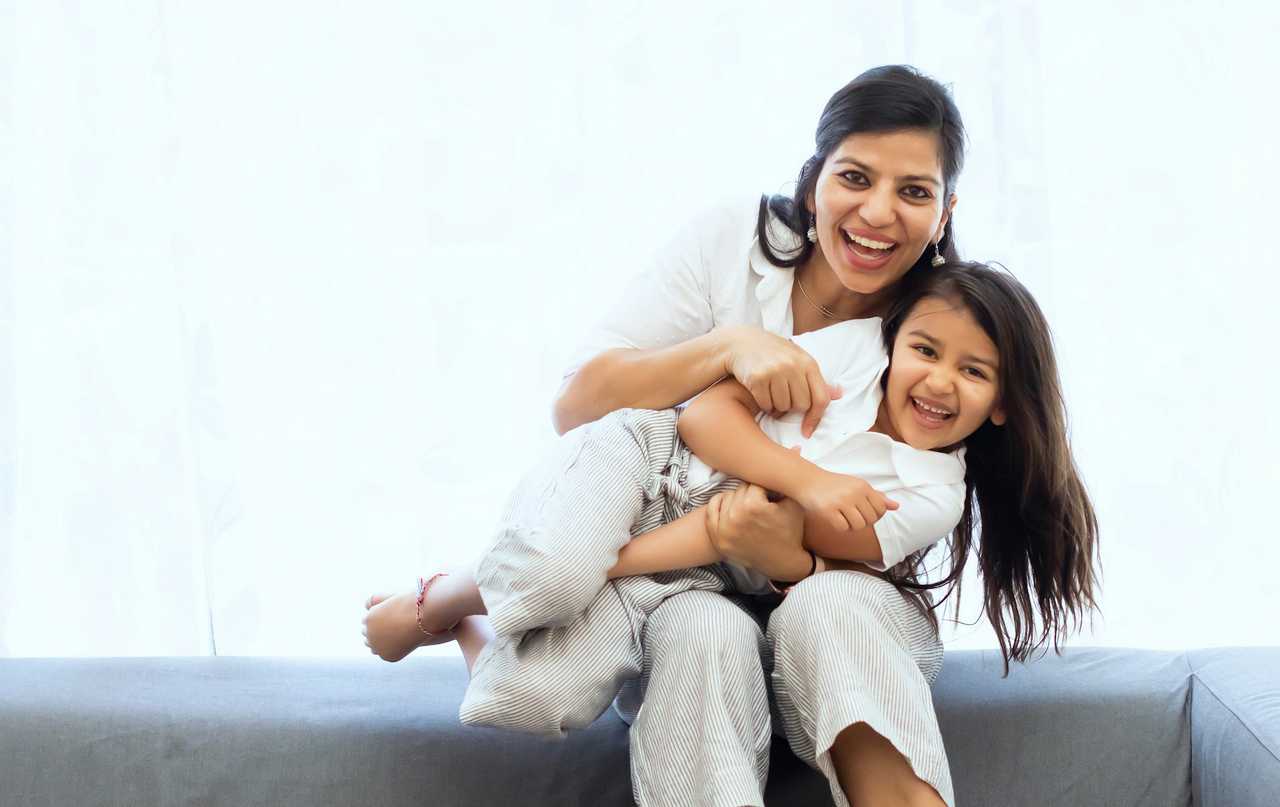 mom and daughter holding each other and laughing after a good morning mom