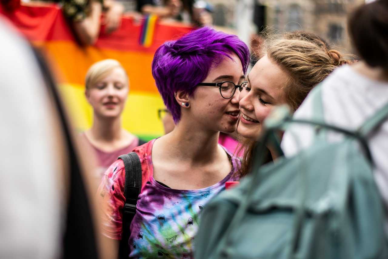 women close to each other in a parade saying good morning wishes