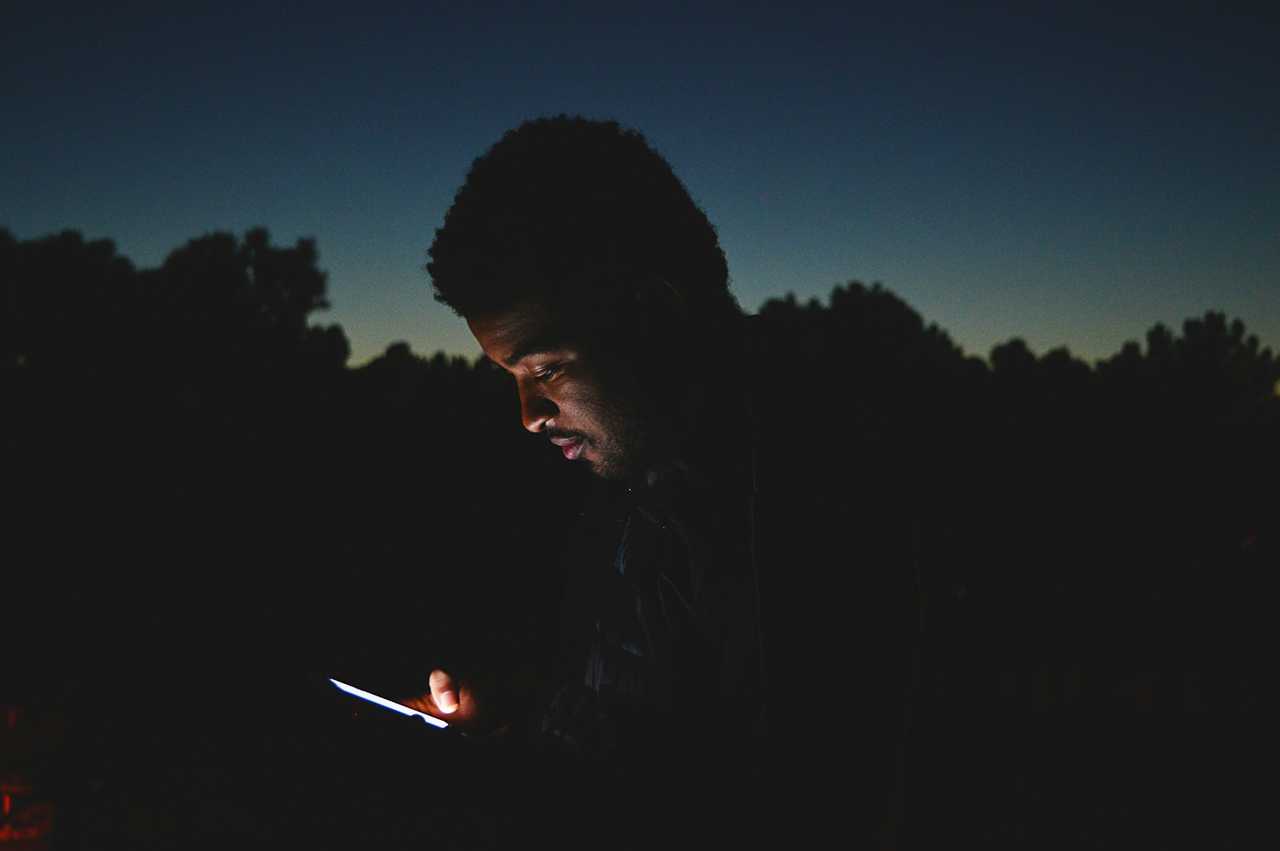 man checking his phone with good night love messages for him at night
