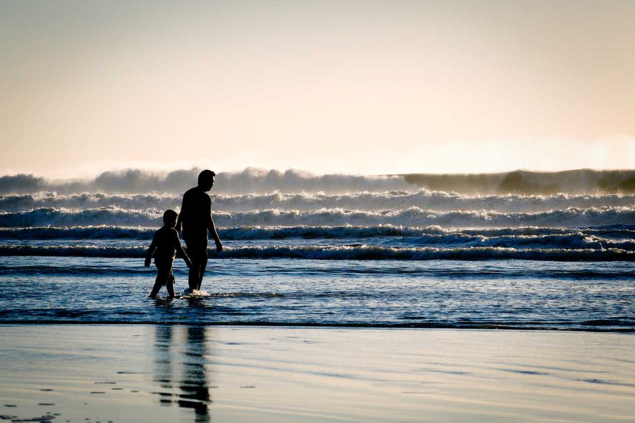dad and son walking in the beach after saying good morning dad messages