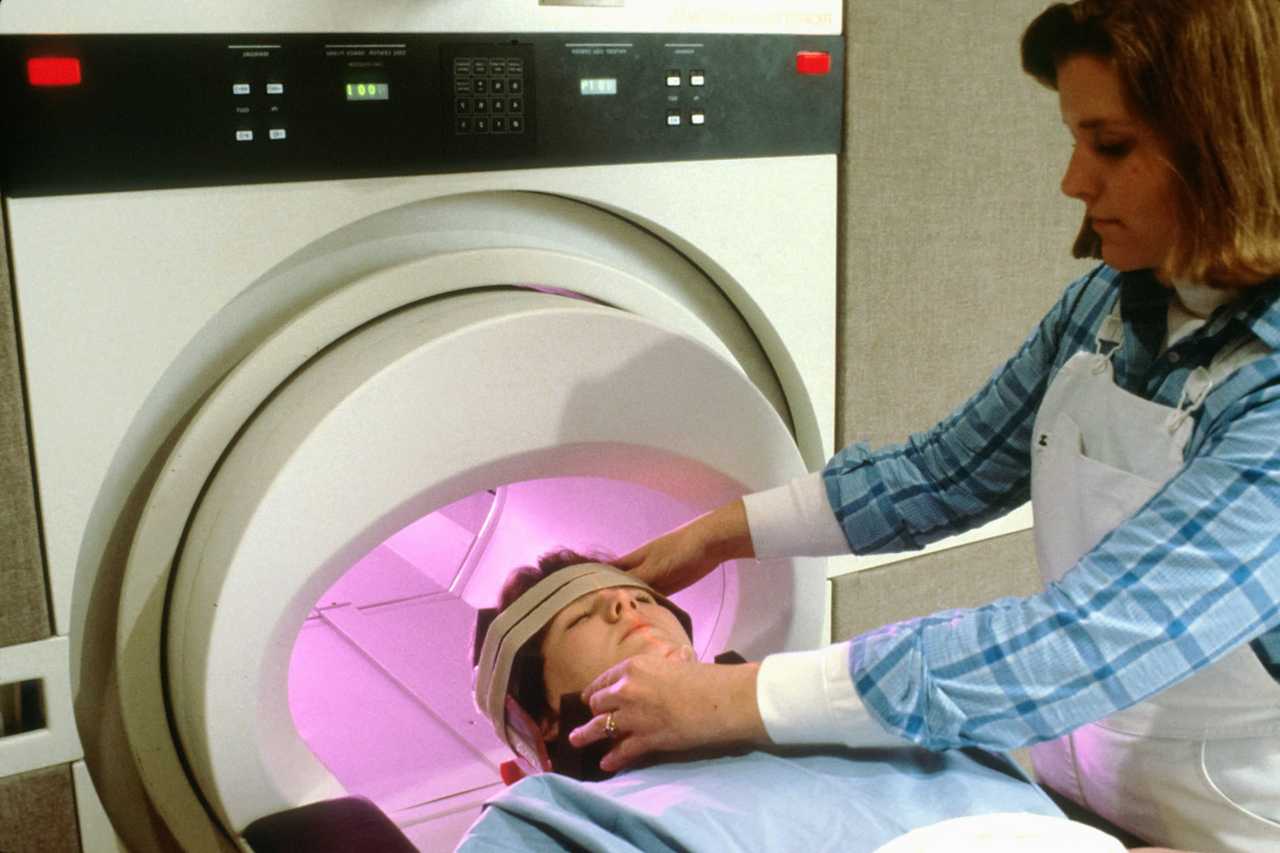 cancer patient ready to enter an mri accompanied by a doctor
