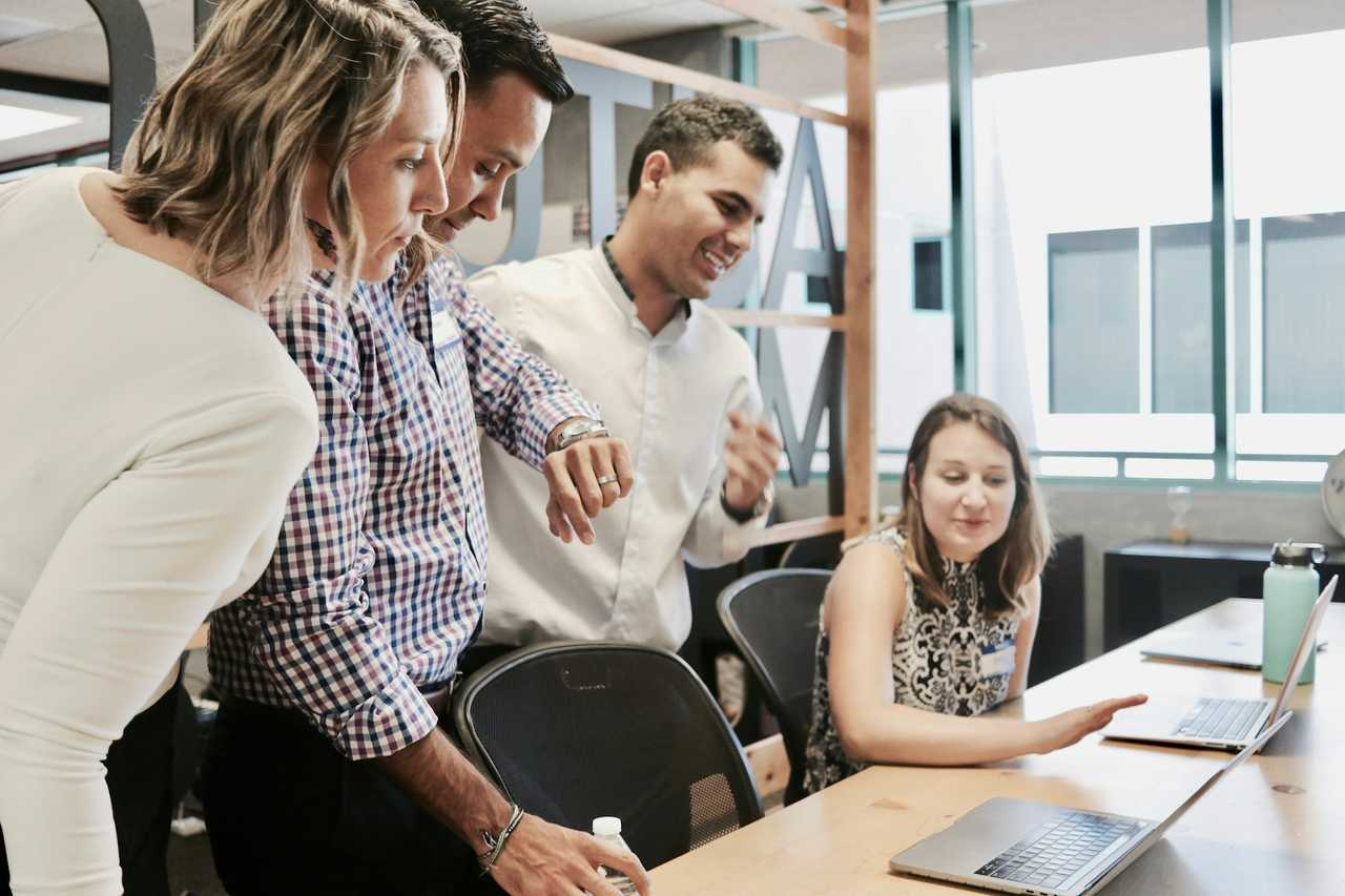 coworkers sharing birthday wishes for another coworker on their birthday