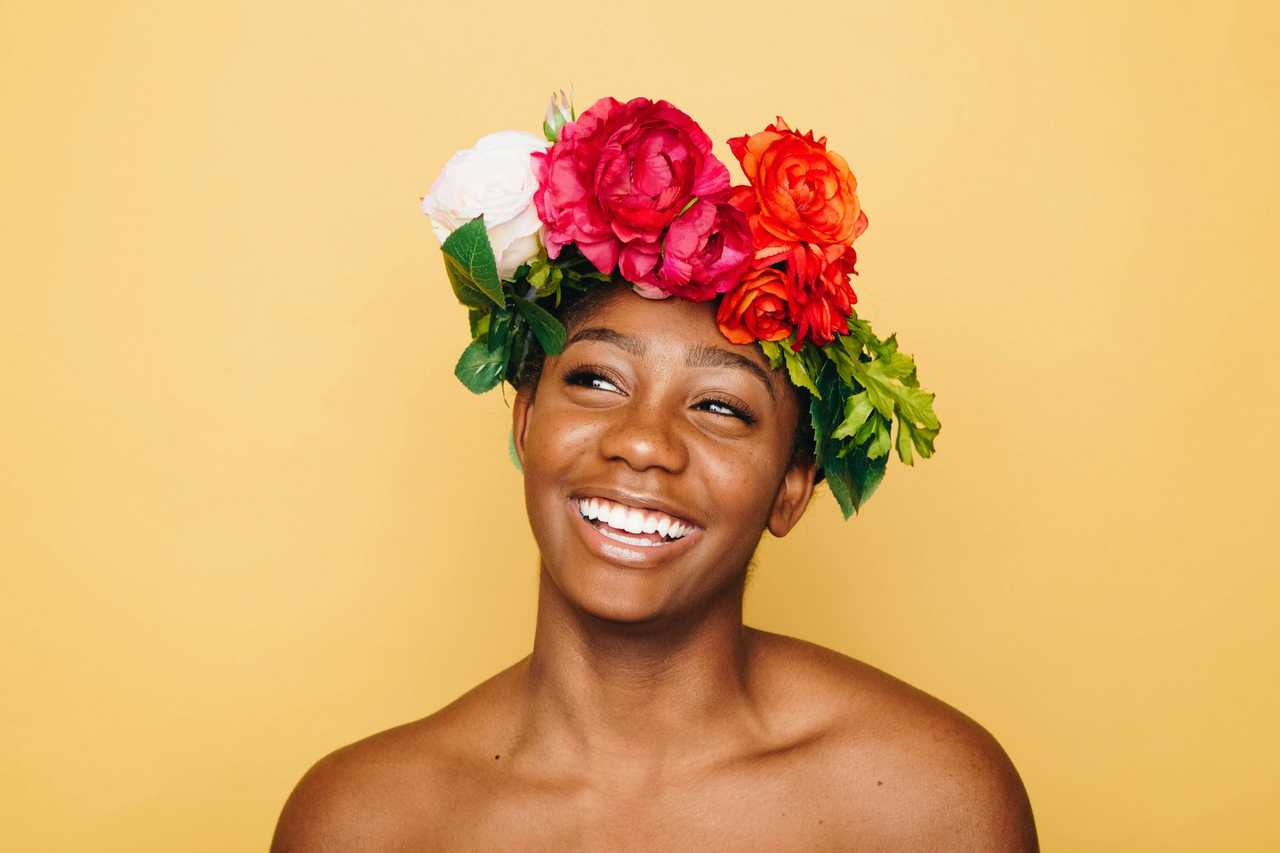woman wearing flowers in the hear smiling getting love messages for her
