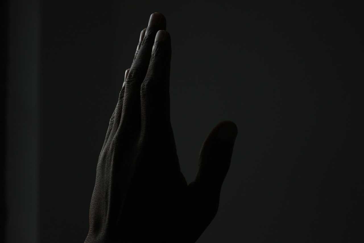 hand held high in prayer to send as good night for a lover