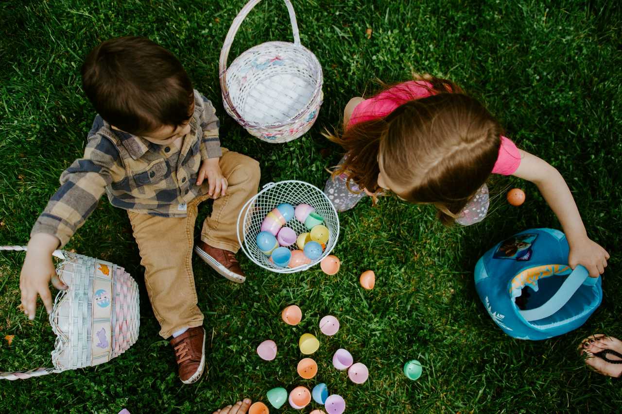 kids putting together eggs in a egg hunt during easter happy easter messages