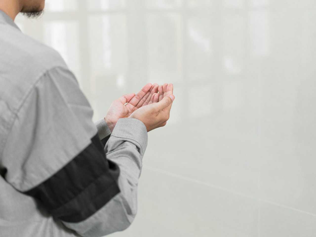 man with hands up in prayer for a good night for a lover