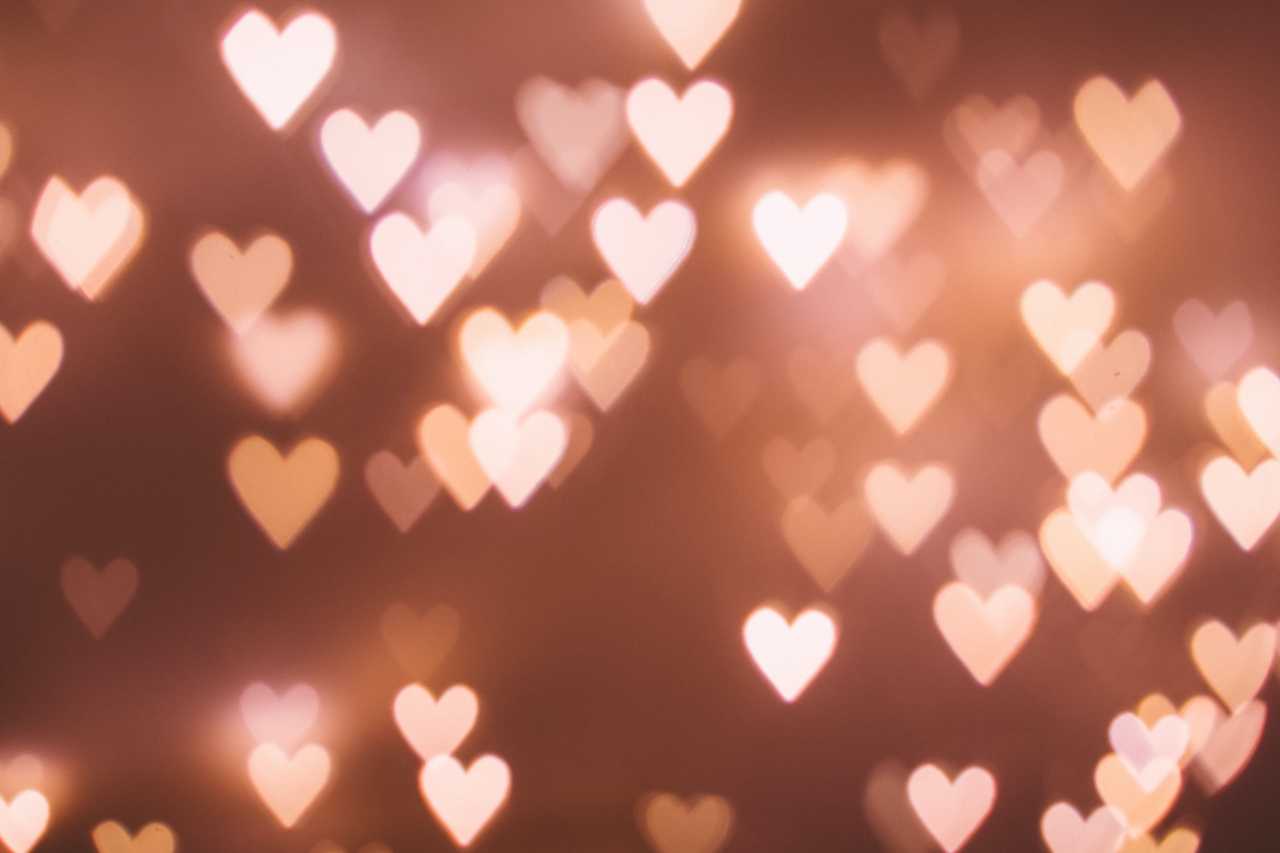 pink heart-shaped lights floating over pink background for valentine's day