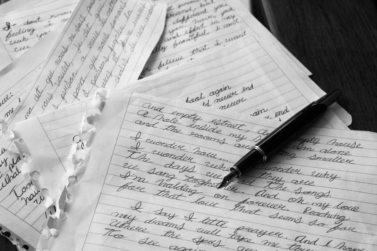 valentine's day messages and quotes written on paper scatter over table with pen