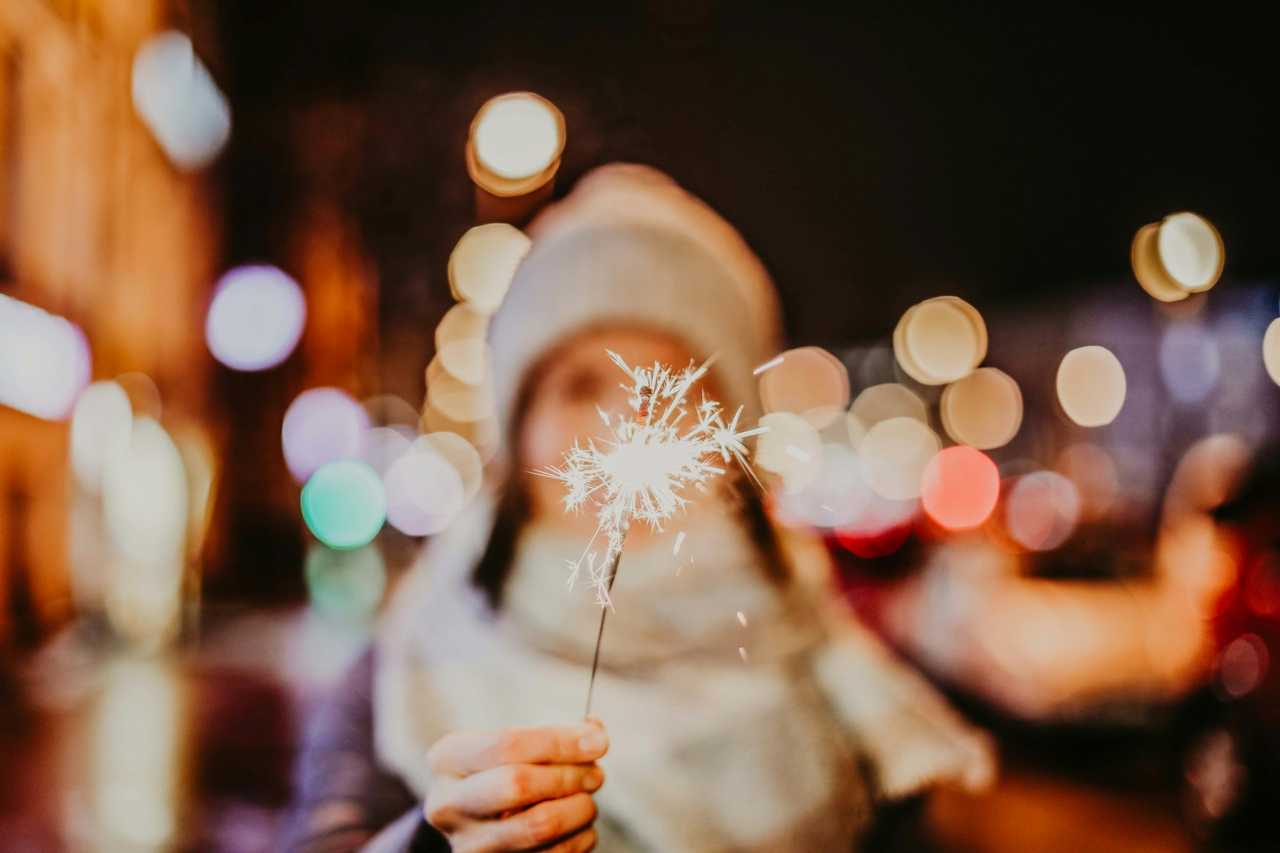 woman holding a sparkling candle on the new year celebration