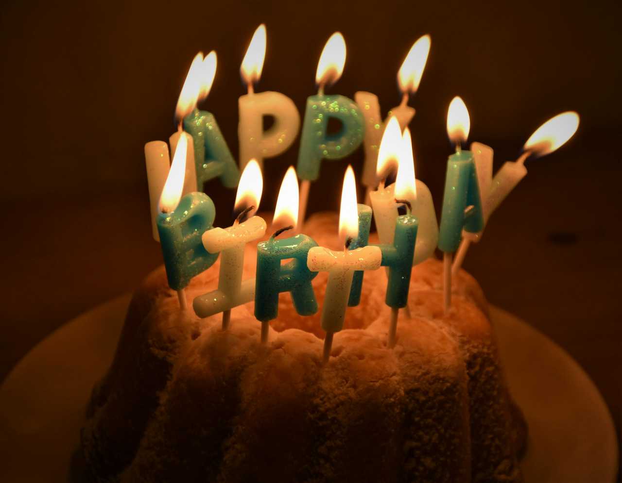 happy birthday candles over a cake for a birthday invitation message