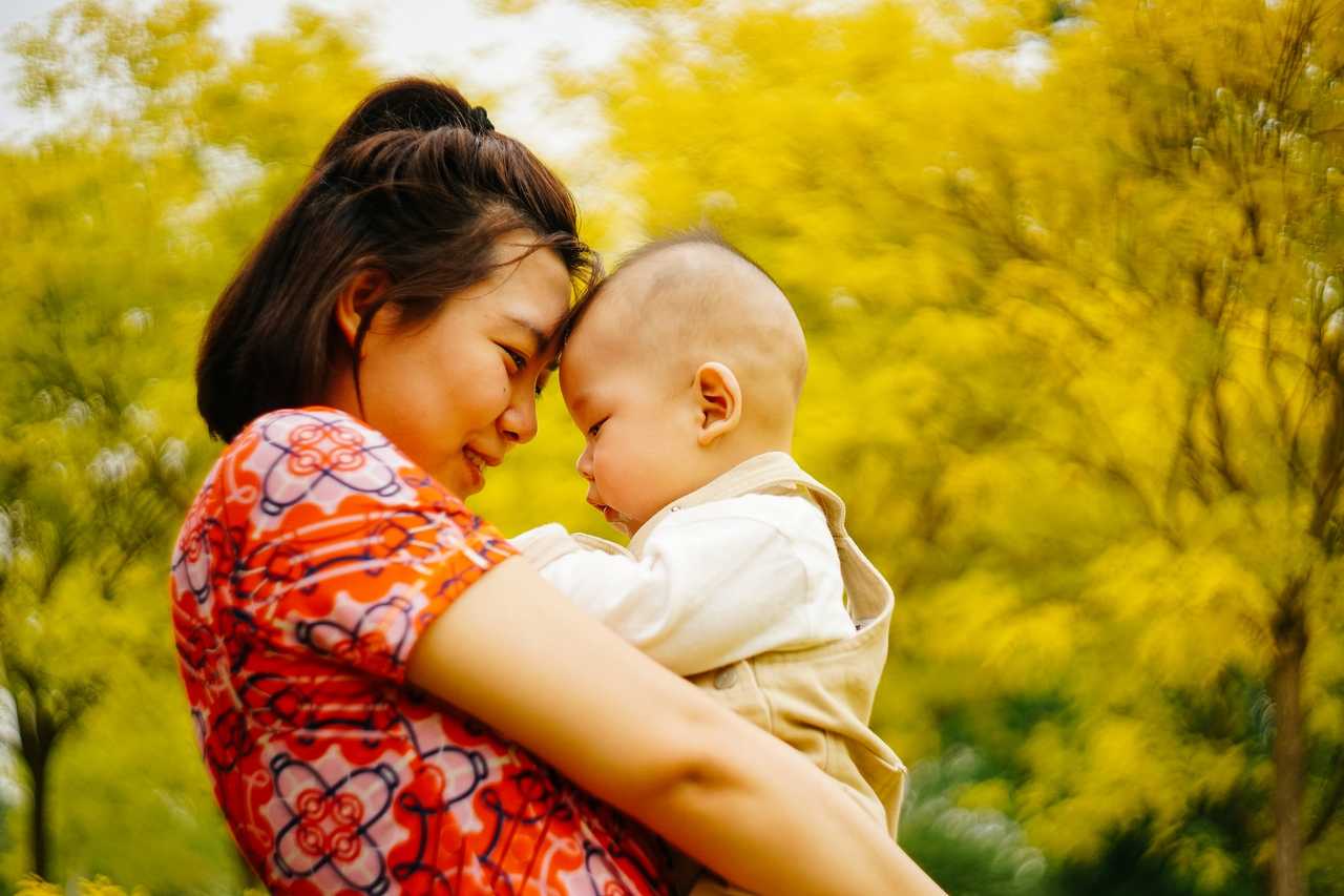 mother holding a baby and touching foreheads getting happy mother's day wishes