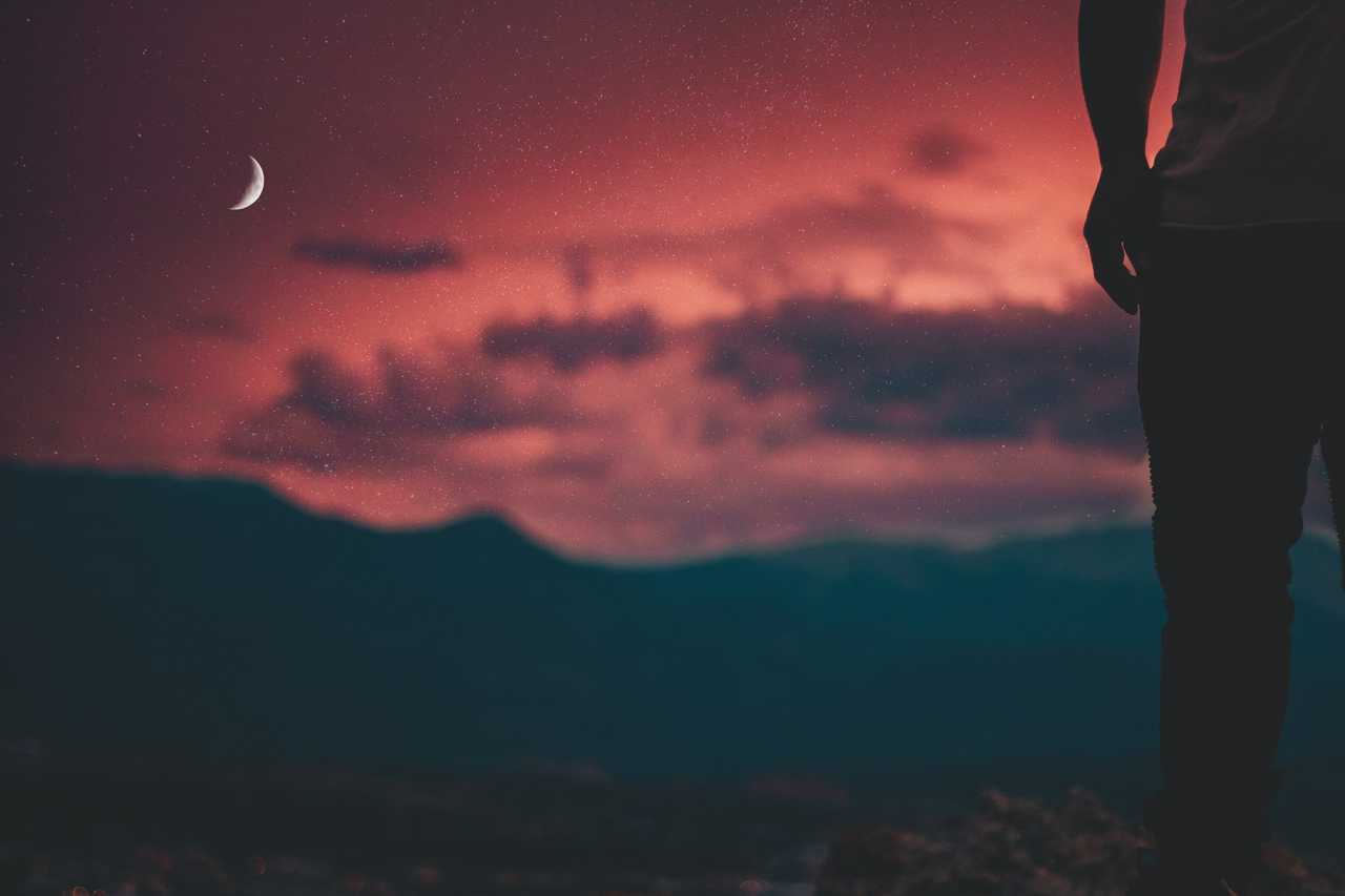 view of the moon in the night sky with partial silhouette of a boyfriend receiving cute good night texts