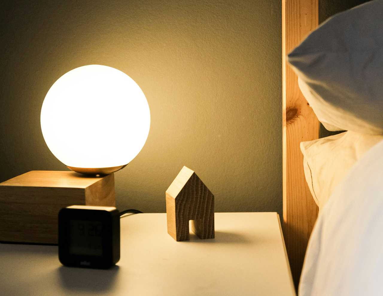 good night messages and detail of a lamp in a desk by a bed at night