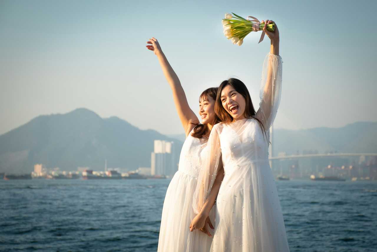 wives celebrating their wedding by the sea