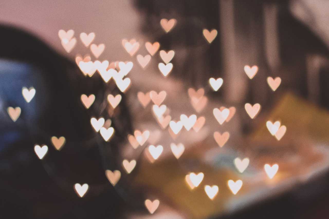 golden heart shaped lights over a blurred background for a love confession text