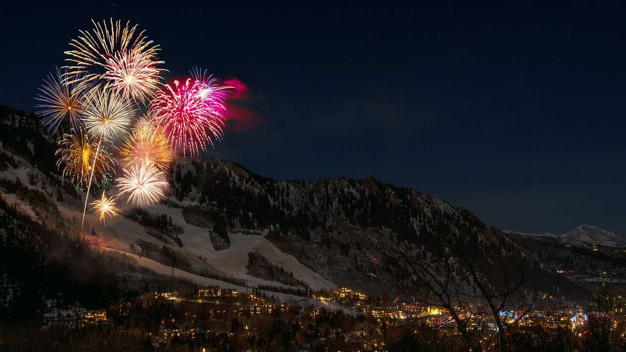 fireworks over a city by the mountains in New Year to send greetings