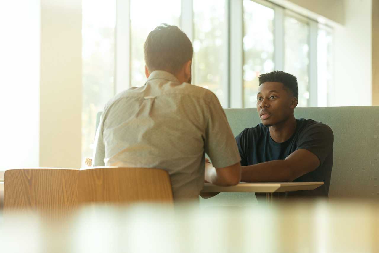 two men discussing in person break up messages