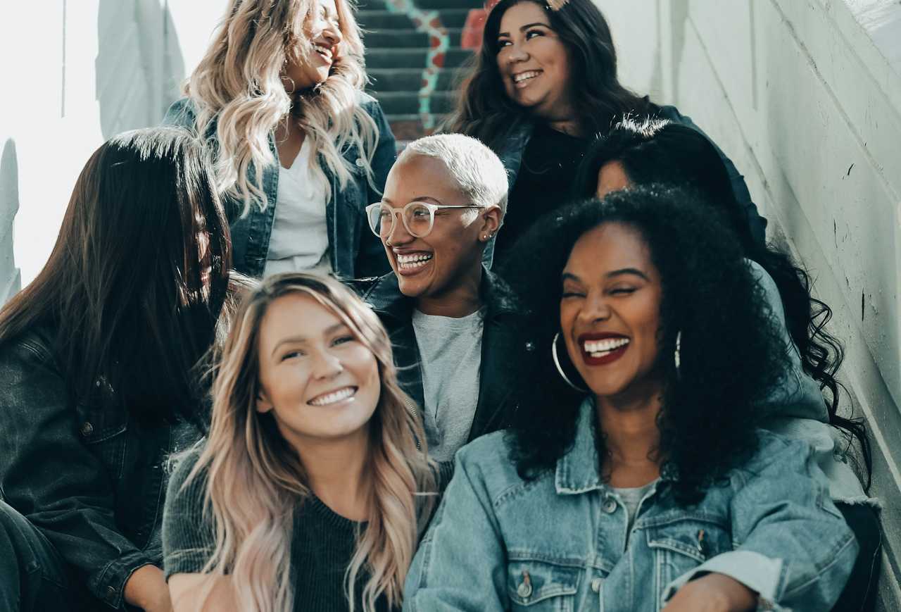 friends seating together and laughing saying short positive messages