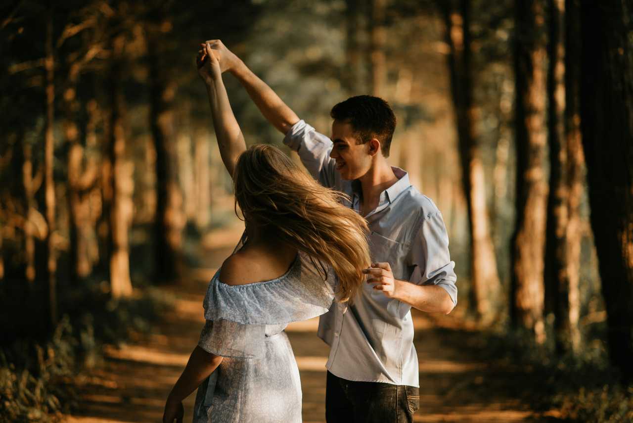 boyfriend spinning girlfriend in the woods on valentine's day