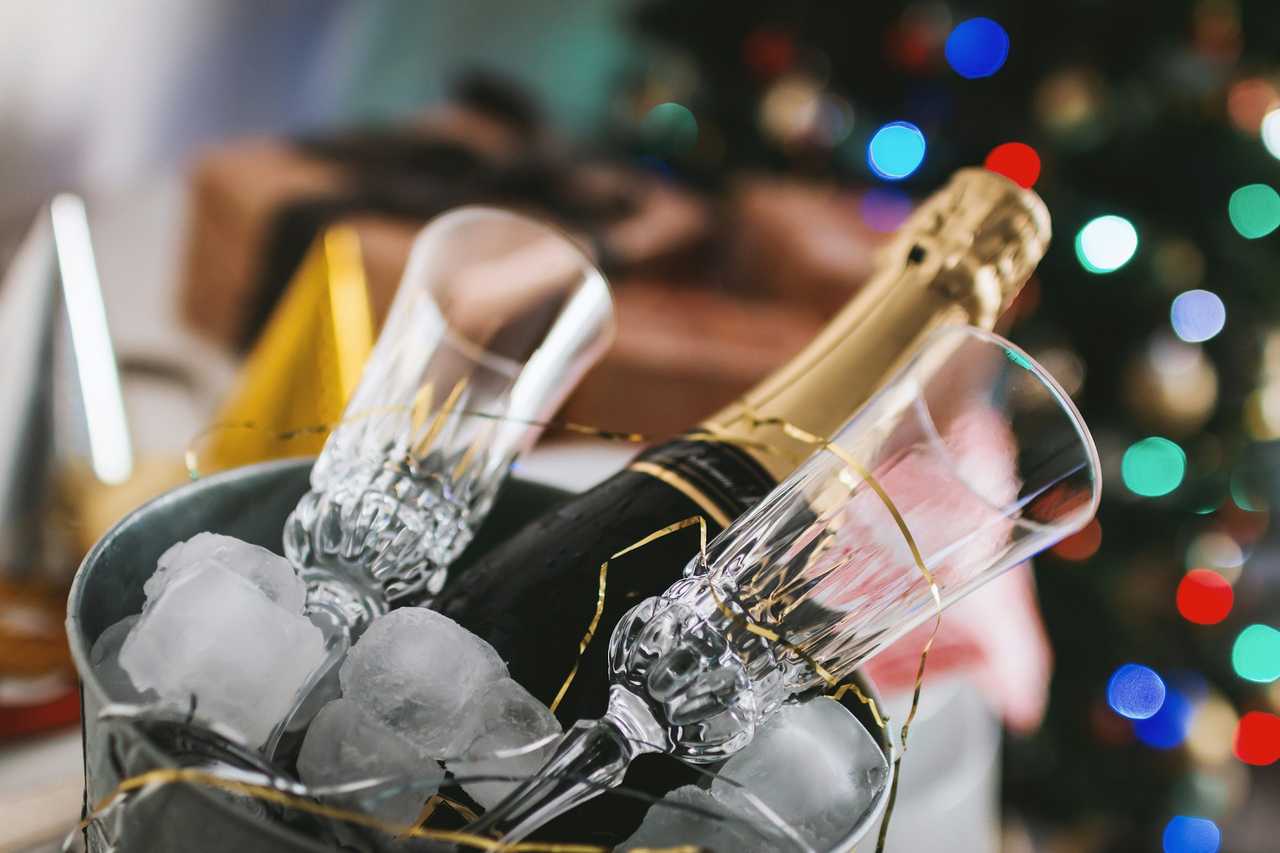 champagne and glasses in a bucket with ice for new year and funny greetings