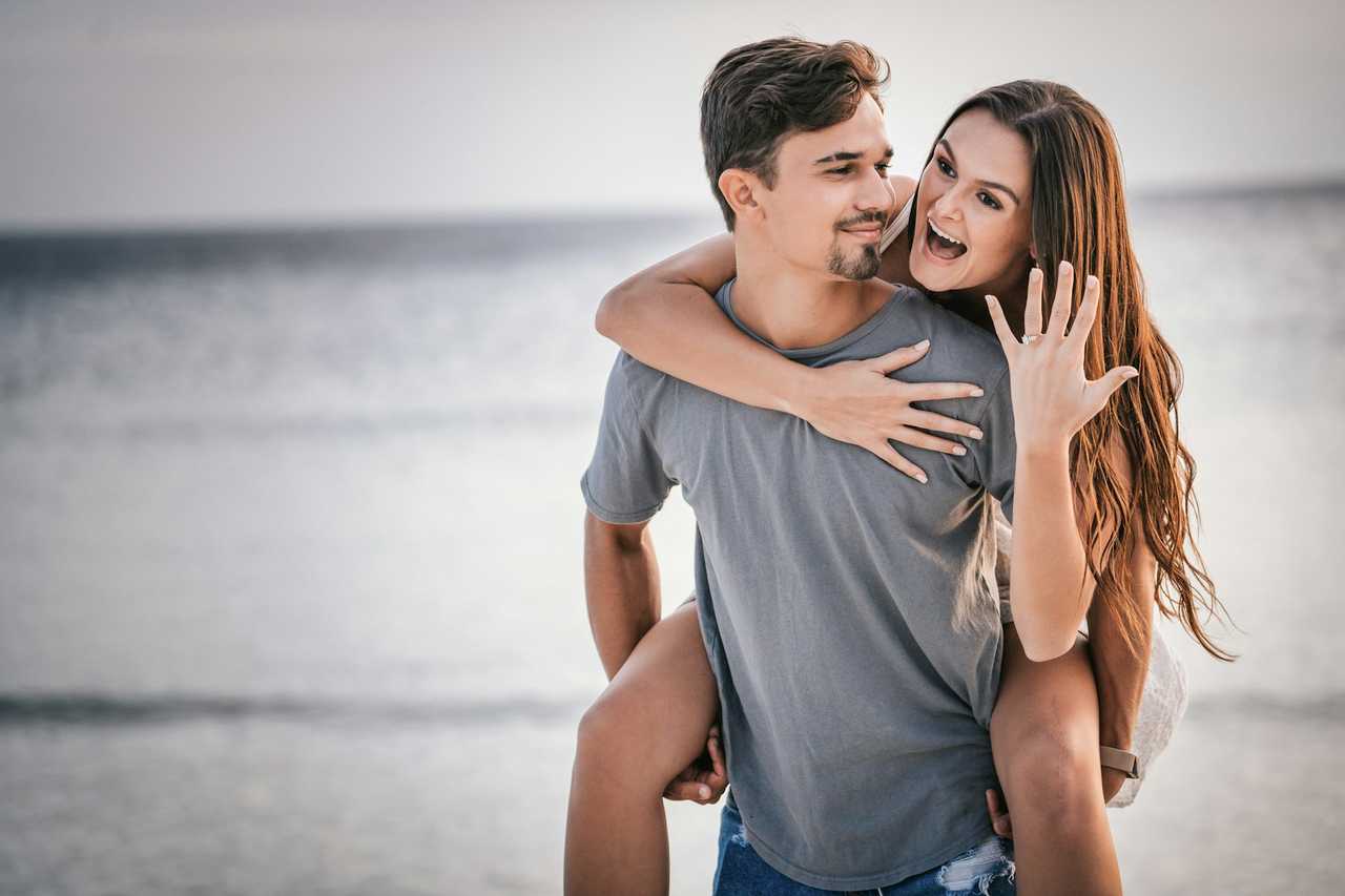 couple celebrating their engagement in the beach