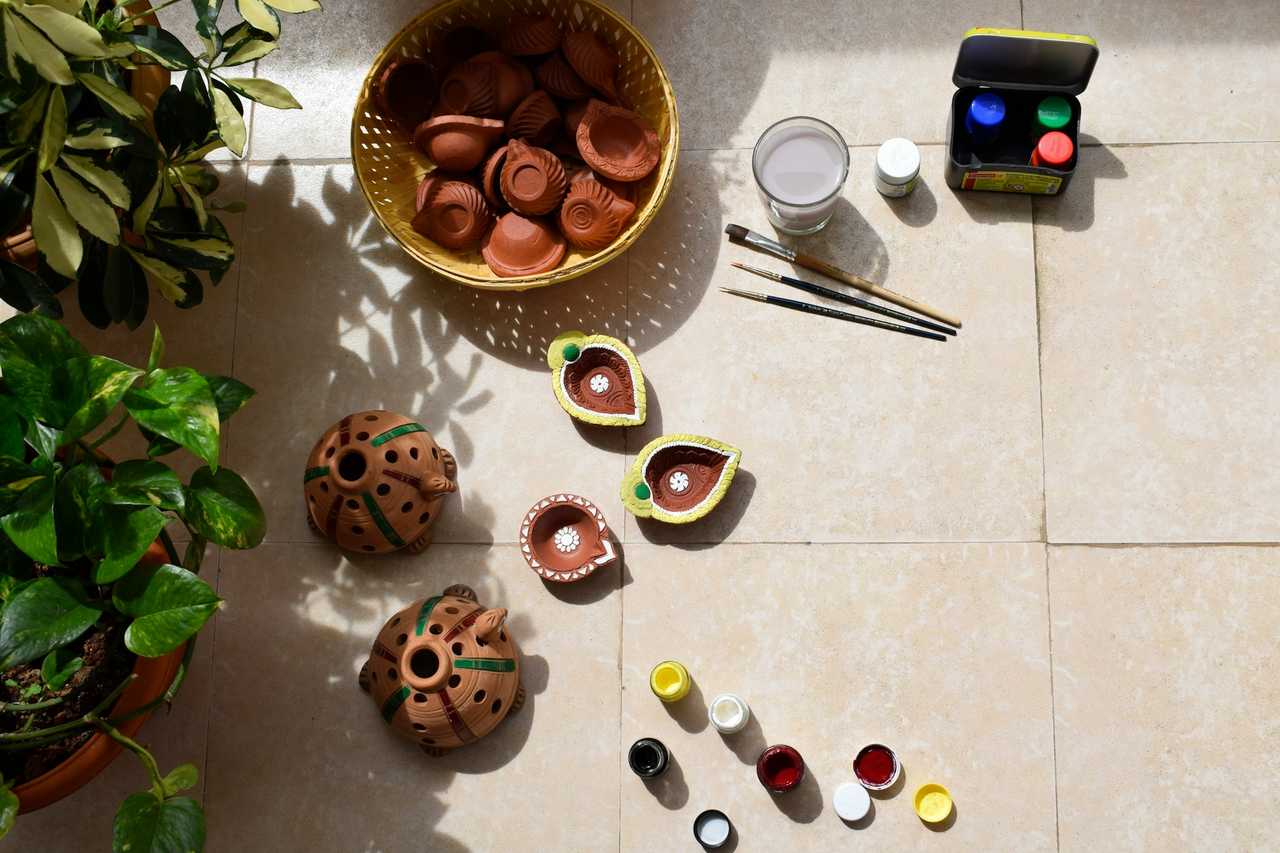 diwali traditional items laid out in the floor for happy diwali wishes